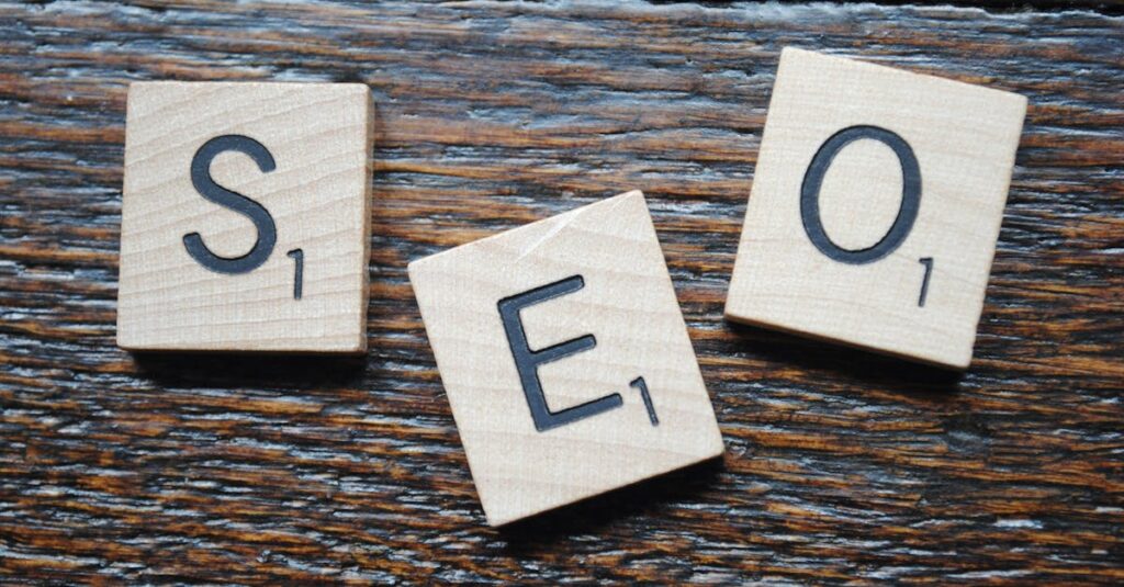 Close-up of Scrabble tiles spelling SEO on a wooden table for content strategy.